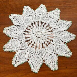 green and white star-shaped crochet doily
